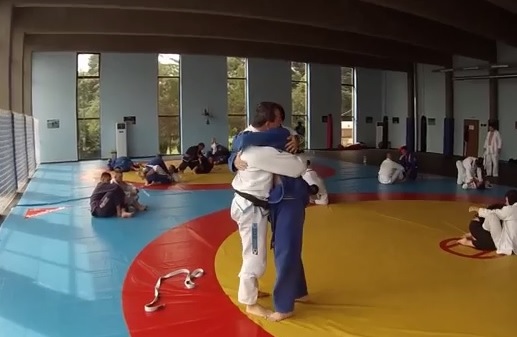 (Video) Instructor Surprises Student During Roll, Ties Blue Belt Around Waist & Promotes Him