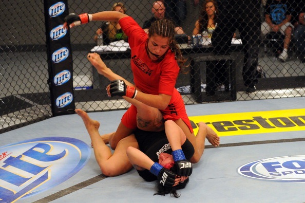 LAS VEGAS, NV - MAY 29:  Julianna Pena (top) punches Gina Mazany in their elimination fight during filming of season eighteen of The Ultimate Fighter on May 29, 2013 in Las Vegas, Nevada. (Photo by Al Powers/Zuffa LLC/Zuffa LLC via Getty Images)