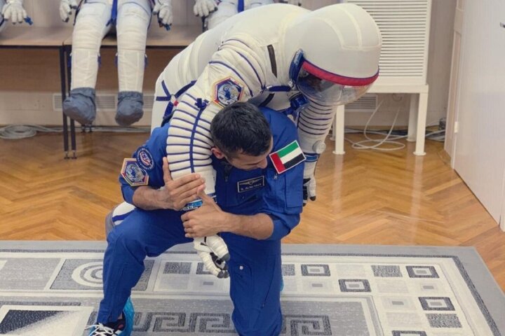 Al Neyadi doing BJJ with a spacesuit